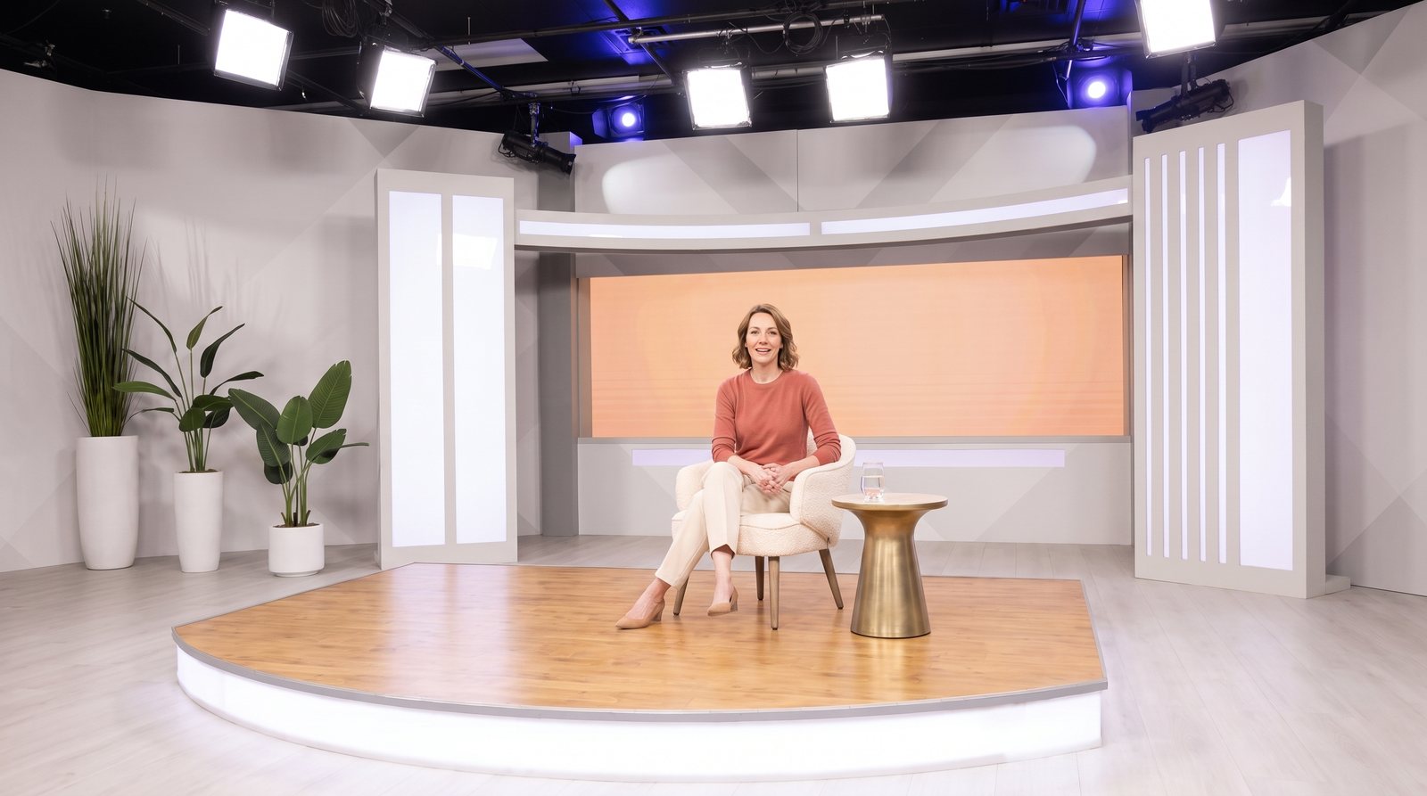 The host stand-in seated in the studio